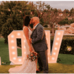 LOVE sign with bride and groom